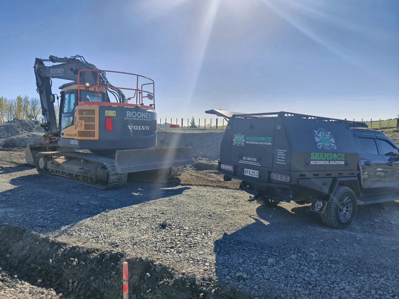 Service truck beside a Volvo crawler excavator