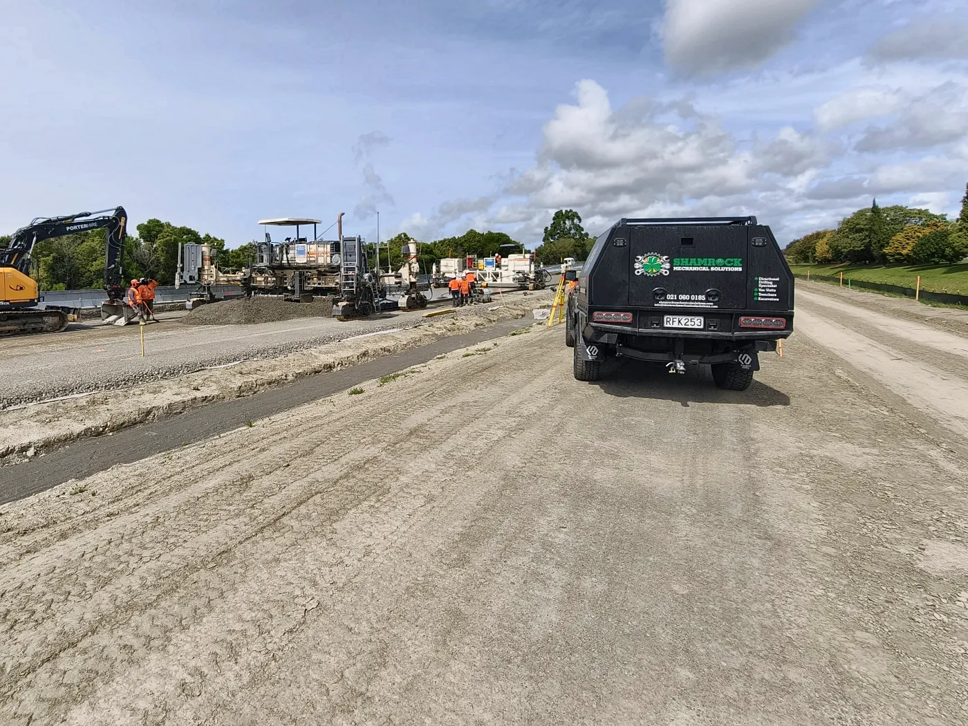 Service truck driving along a roadworks corridor